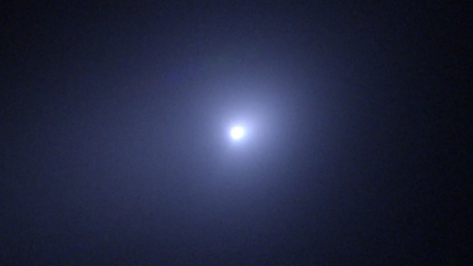3I/ATLAS, the third confirmed interstellar object, showing a sunward jet and blue-fluorescing coma
