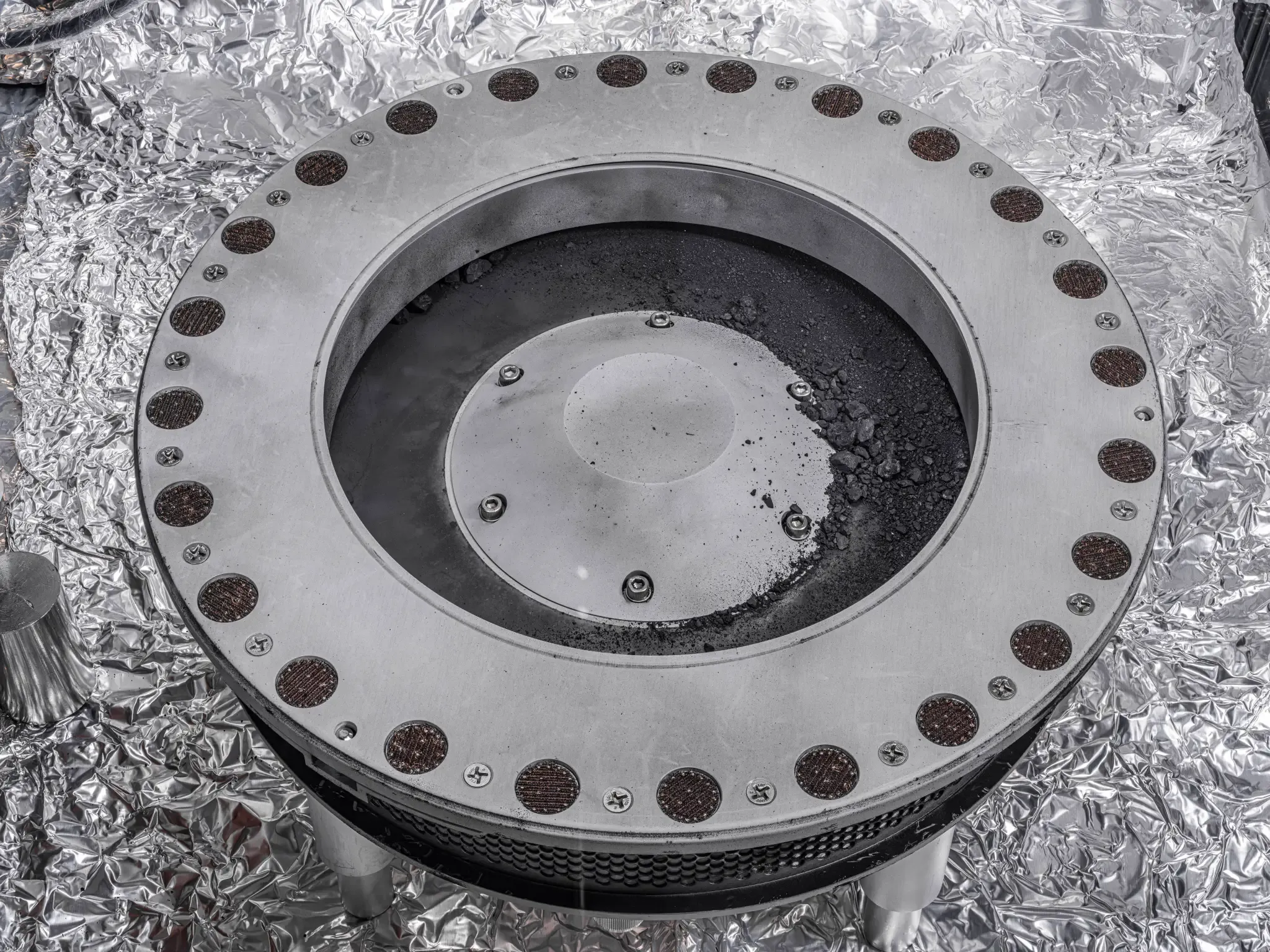 Pristine sample of asteroid Bennu returned by OSIRIS-REx, photographed in NASA's Johnson Space Center clean room