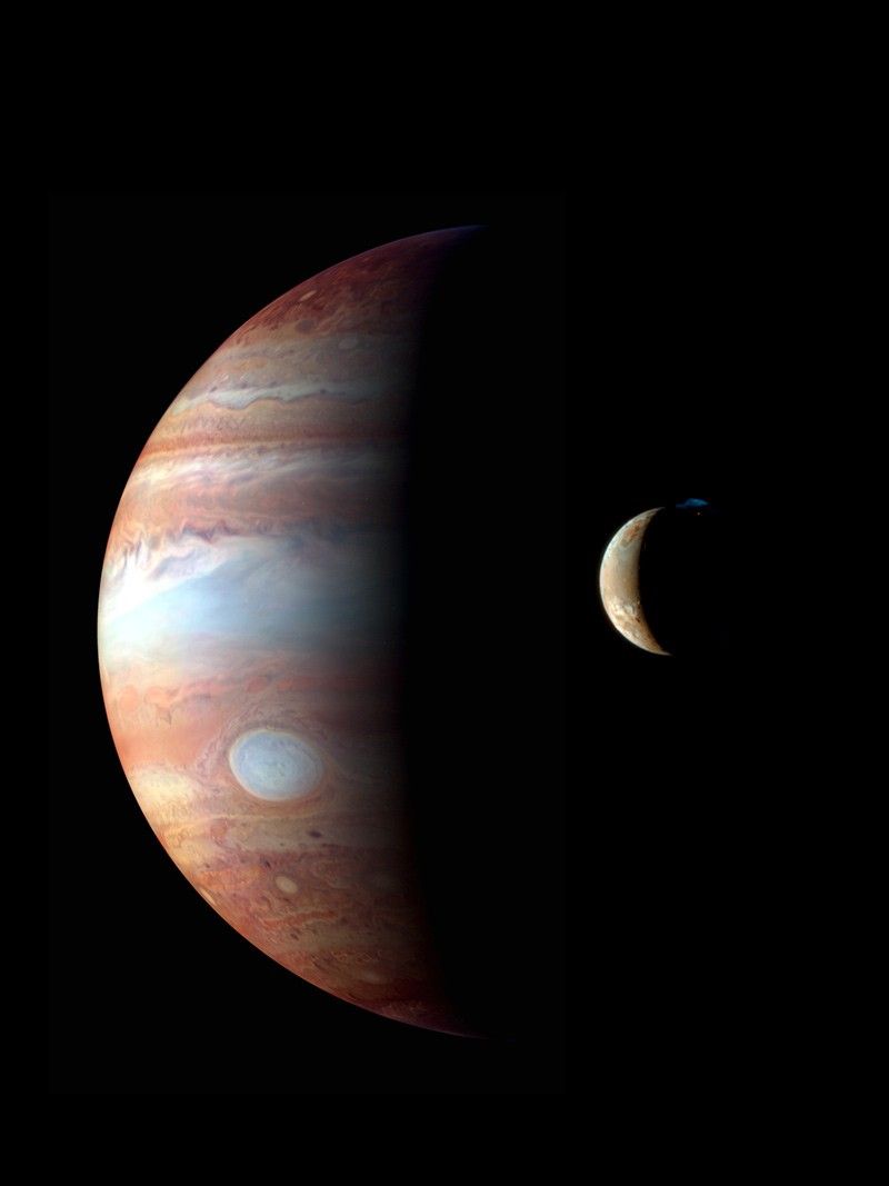 Jupiter and its volcanic moon Io photographed by NASA New Horizons spacecraft