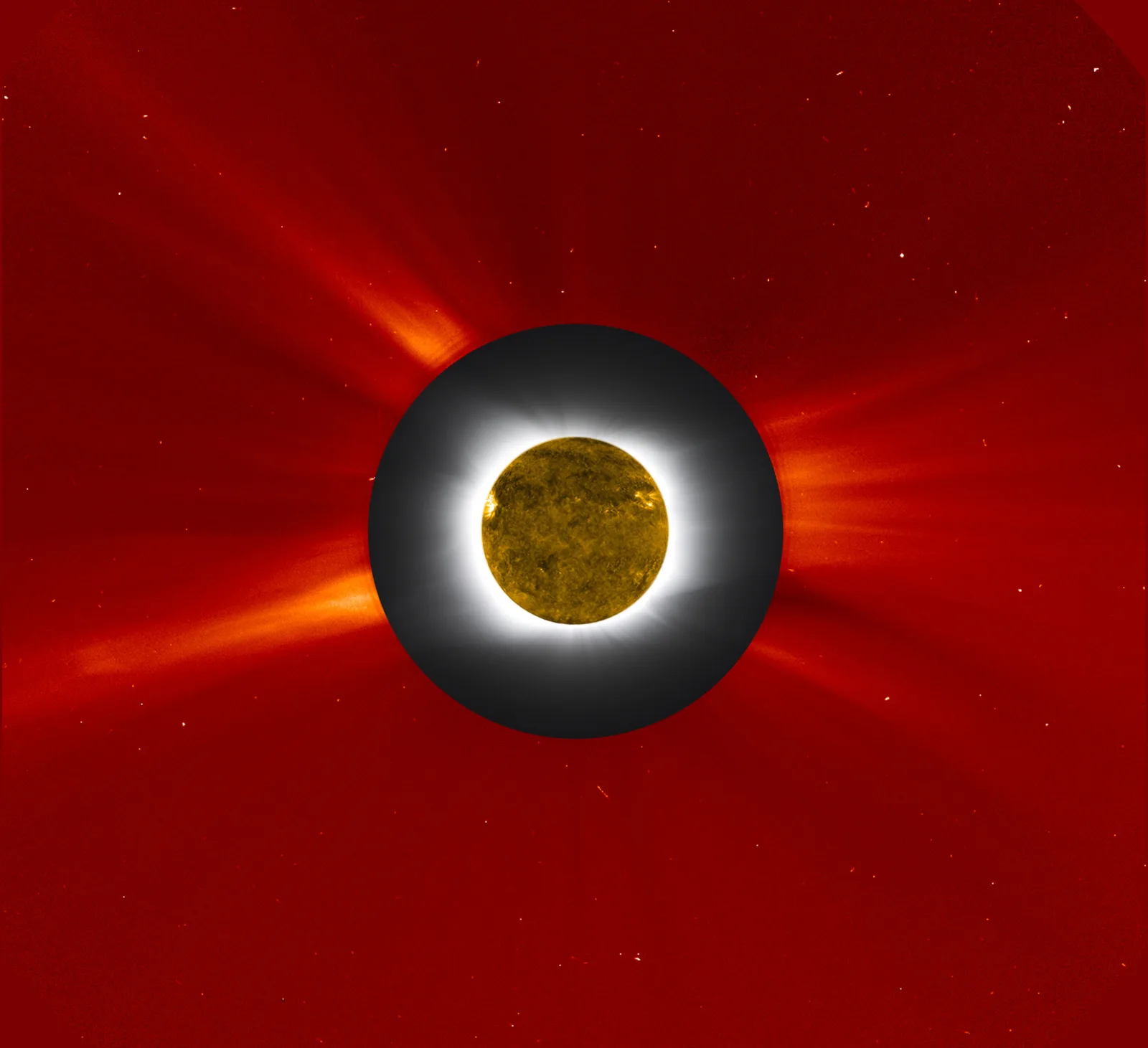 The Sun's wispy outer atmosphere, the corona, glowing as pale streamers against the black of space during a total eclipse.